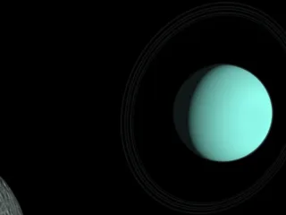 Planet Uranus and its moon Umbriel